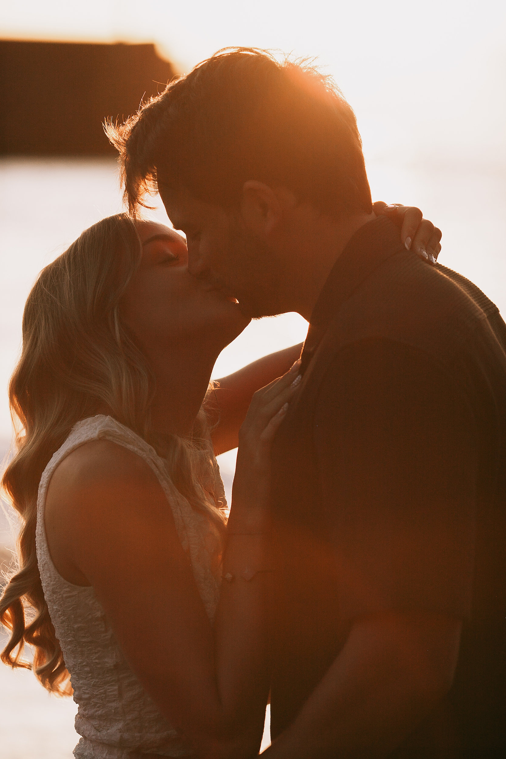 Silhouetted kiss with sunset burning behind, Seixal, Madeira