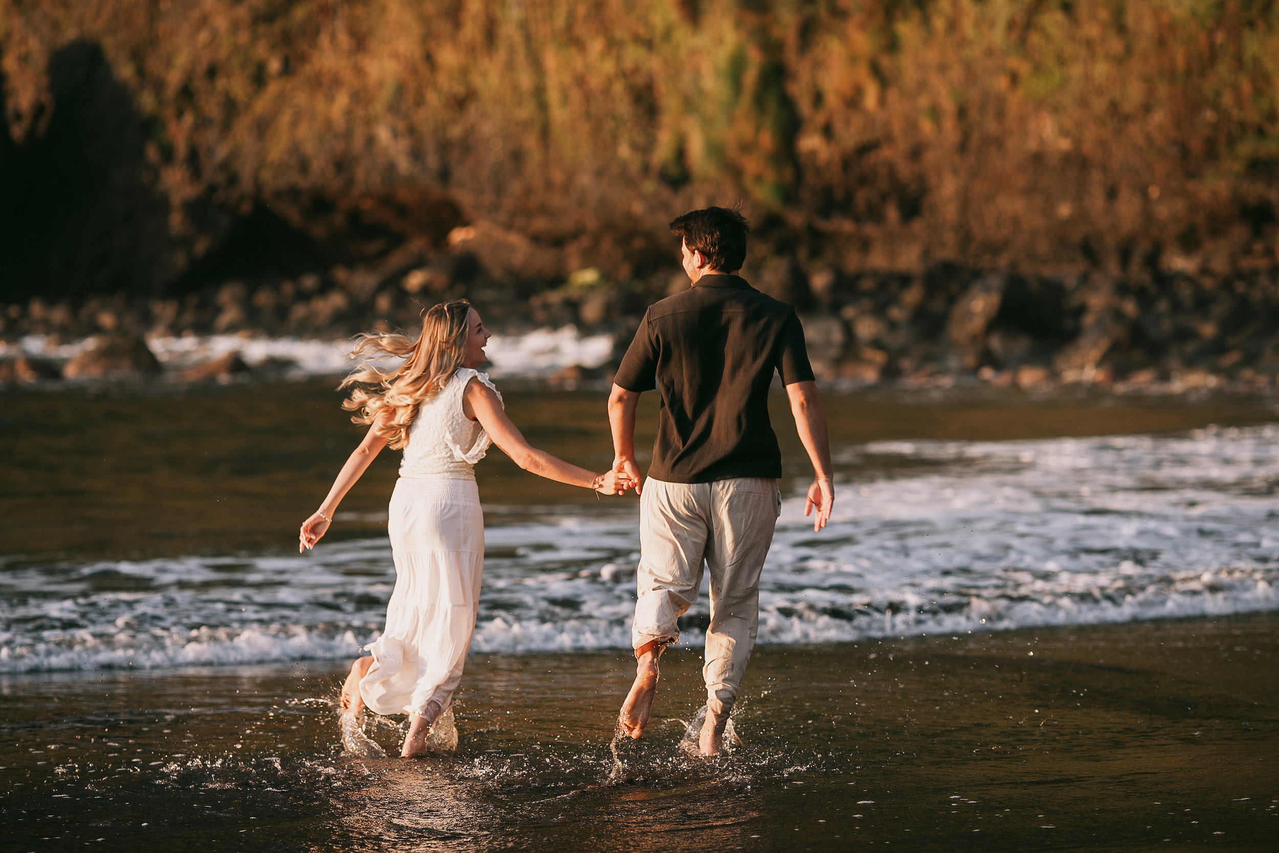 Splashing through the golden water together, Seixal Beach, Madeira