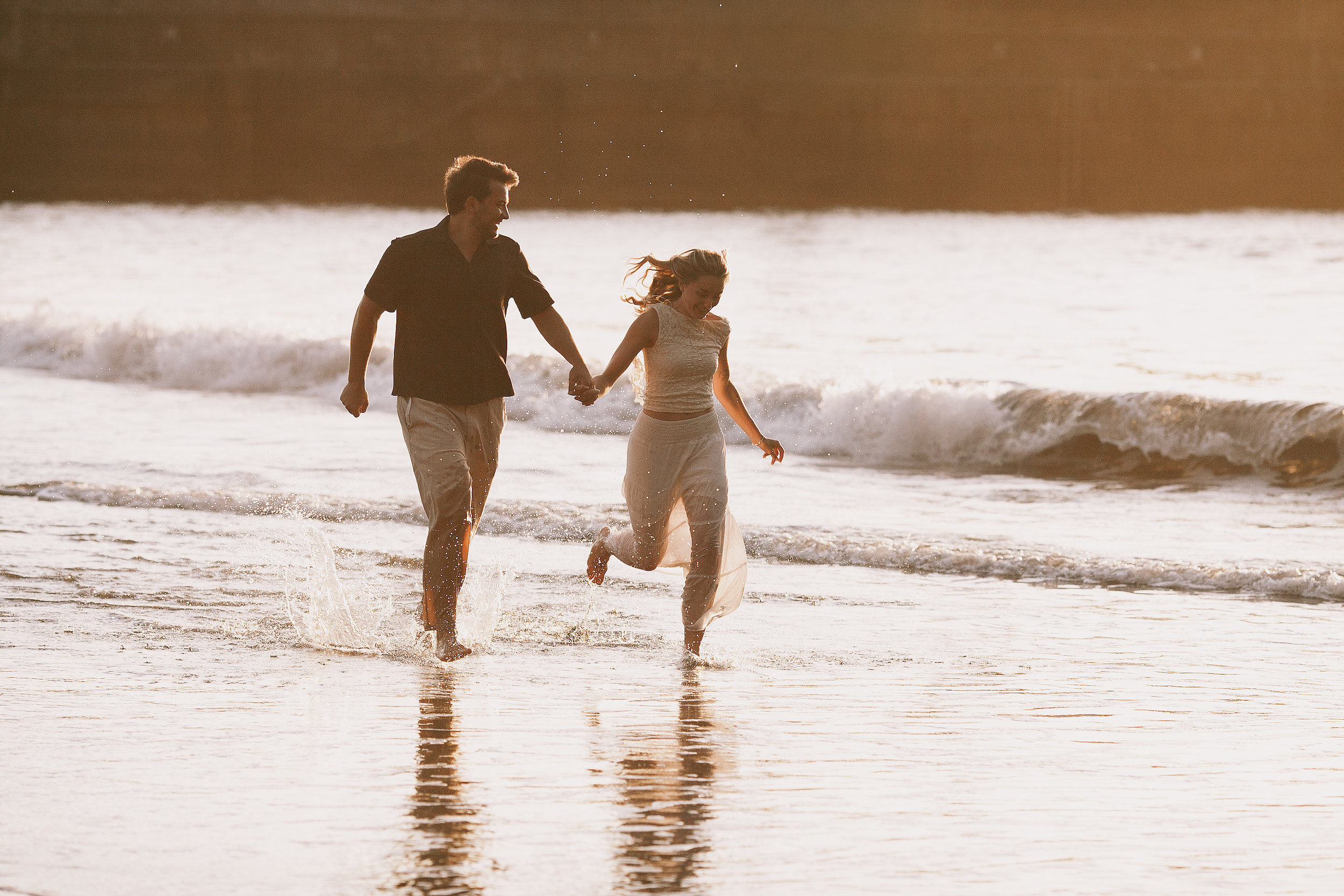 Running out of the waves laughing, golden hour at Seixal, Madeira