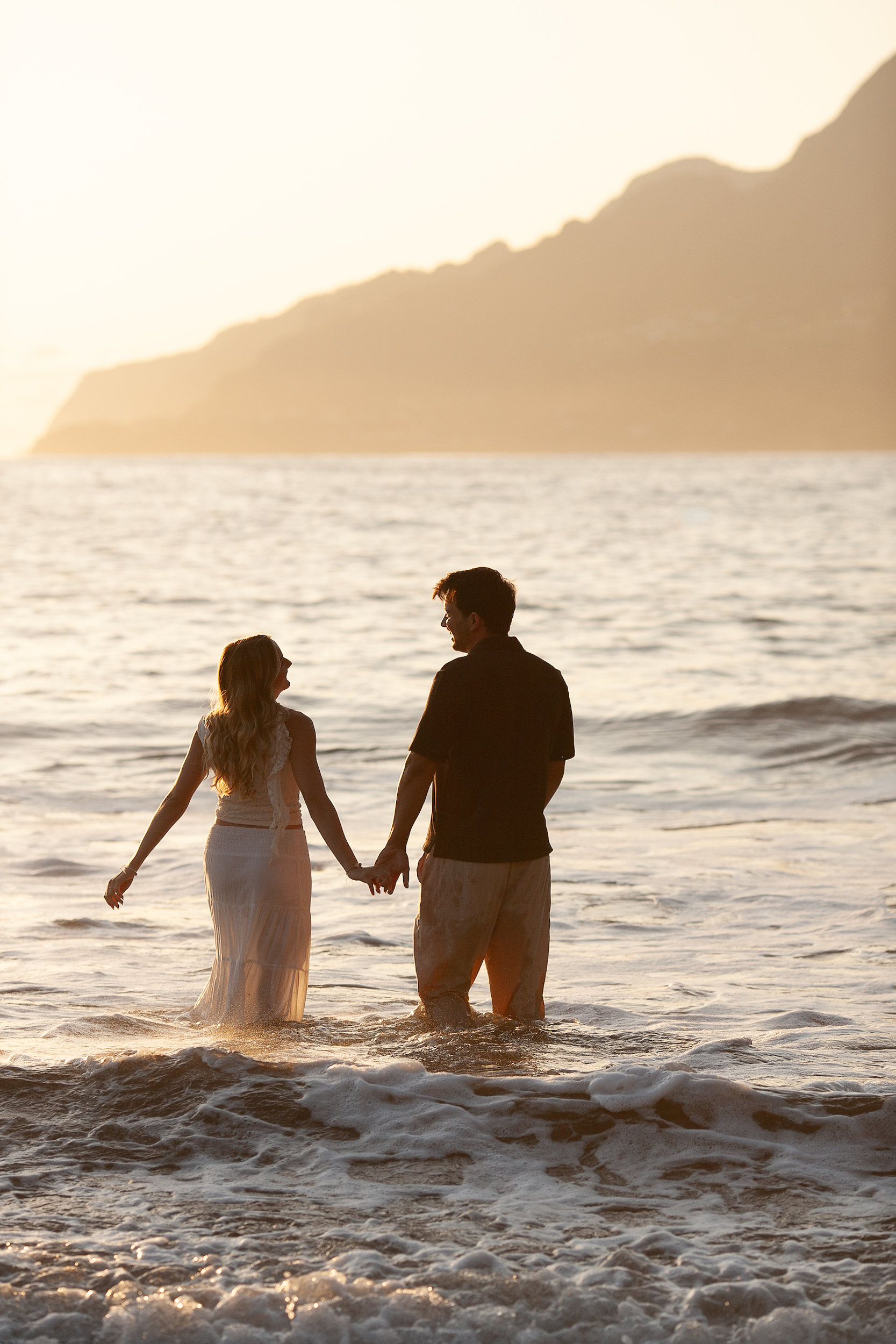 Wading deeper into the golden water hand in hand, Seixal, Madeira