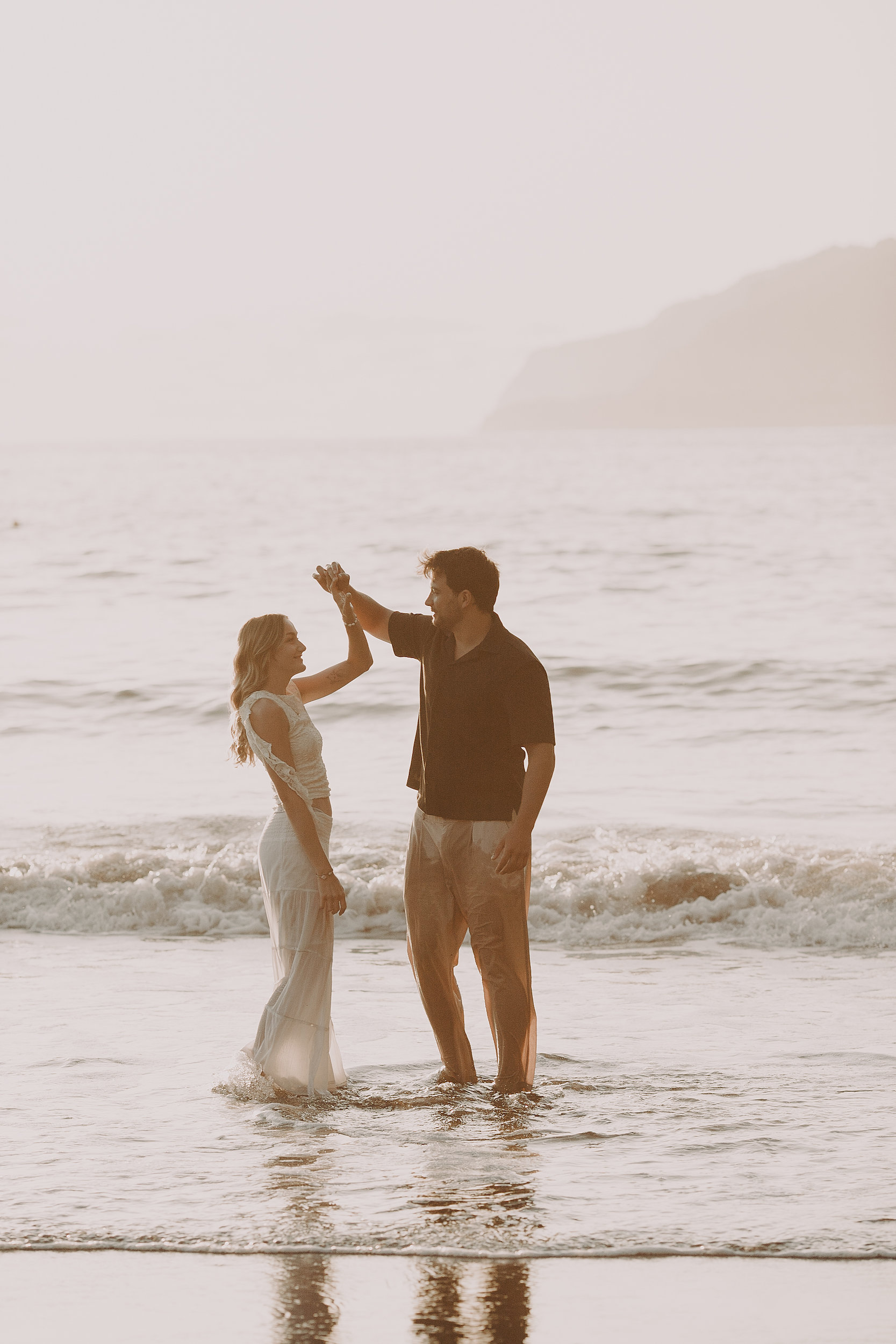 He twirls her hand in the waves, Seixal, Madeira