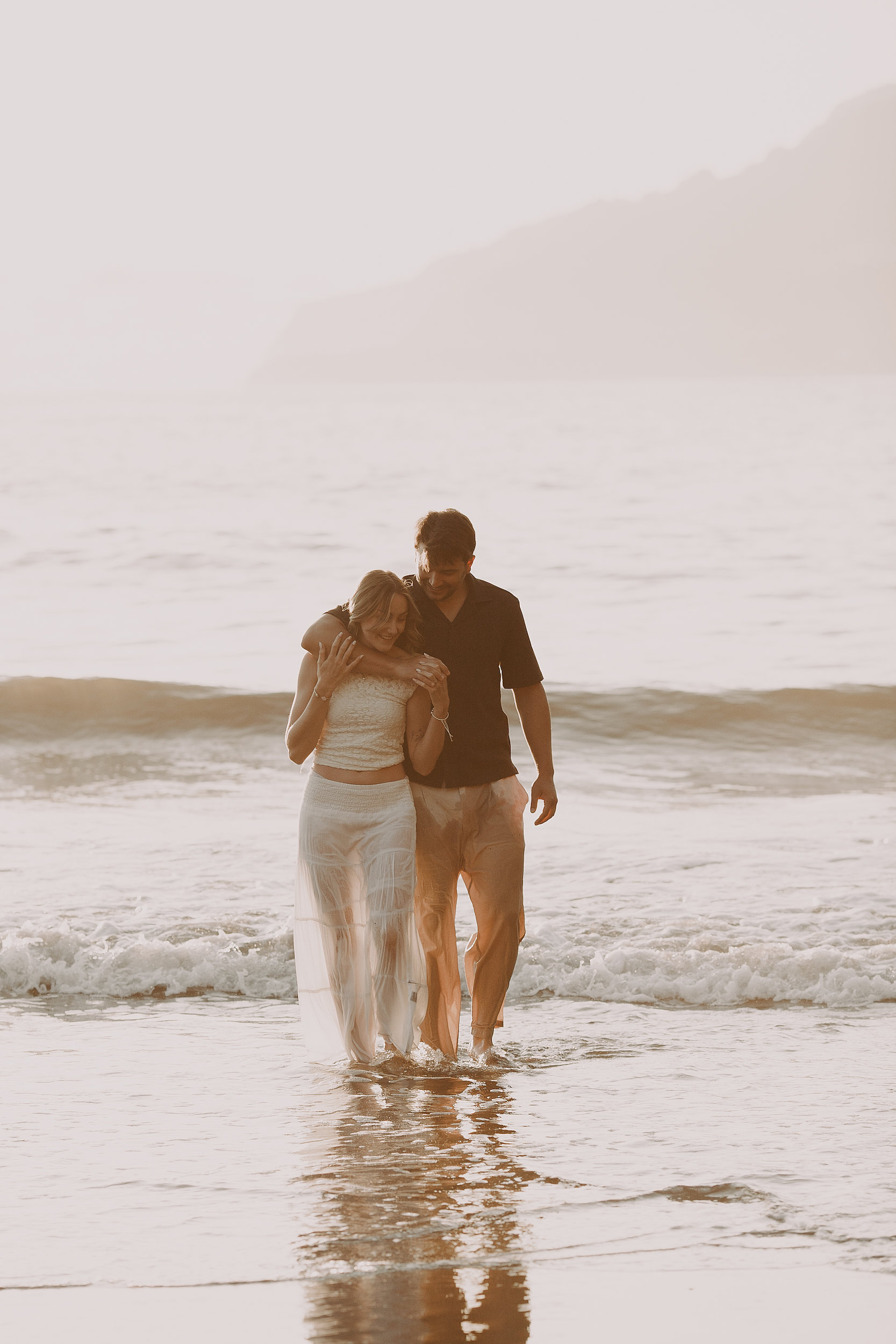 Huddled together laughing as the surf pushes past, Seixal Beach, Madeira