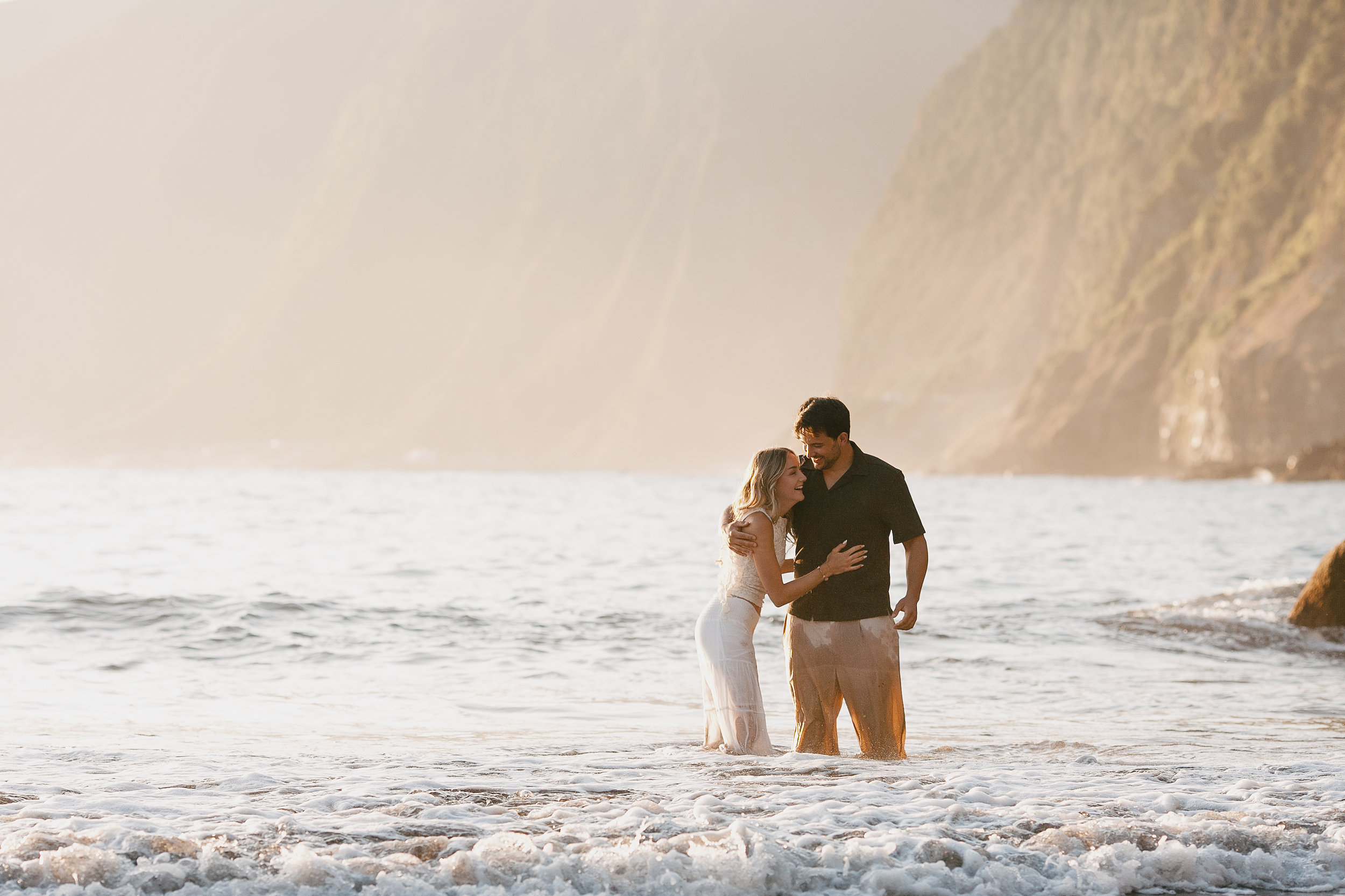 A kiss in the breaking surf at dusk, Seixal, Madeira
