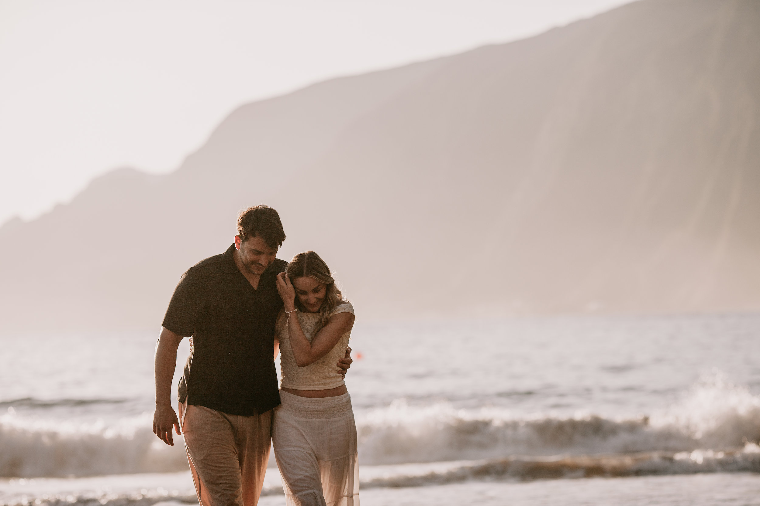 Walking out of the water together at nightfall, Seixal Beach, Madeira
