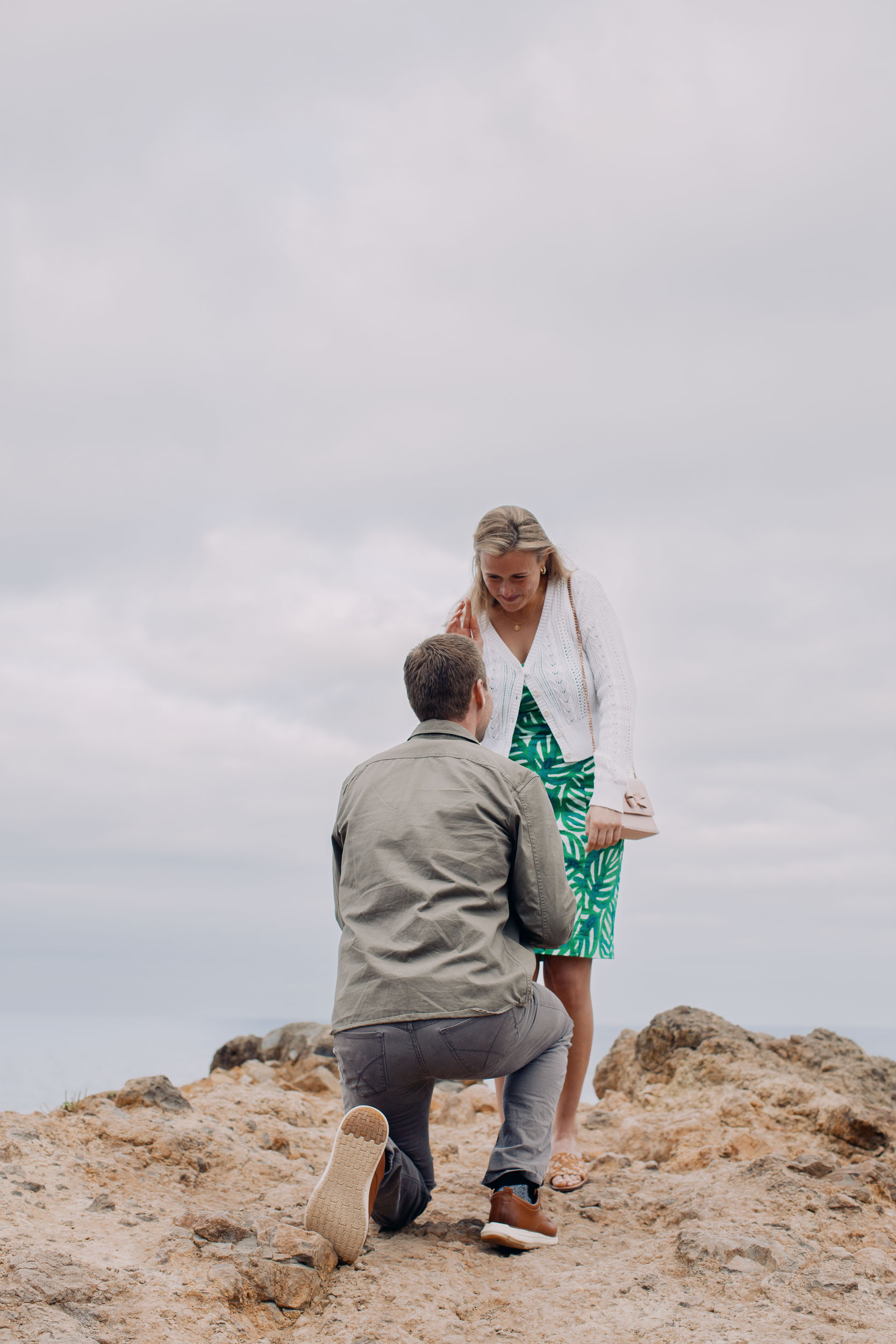 Couple laughing at clifftop after proposal, Funchal, Madeira