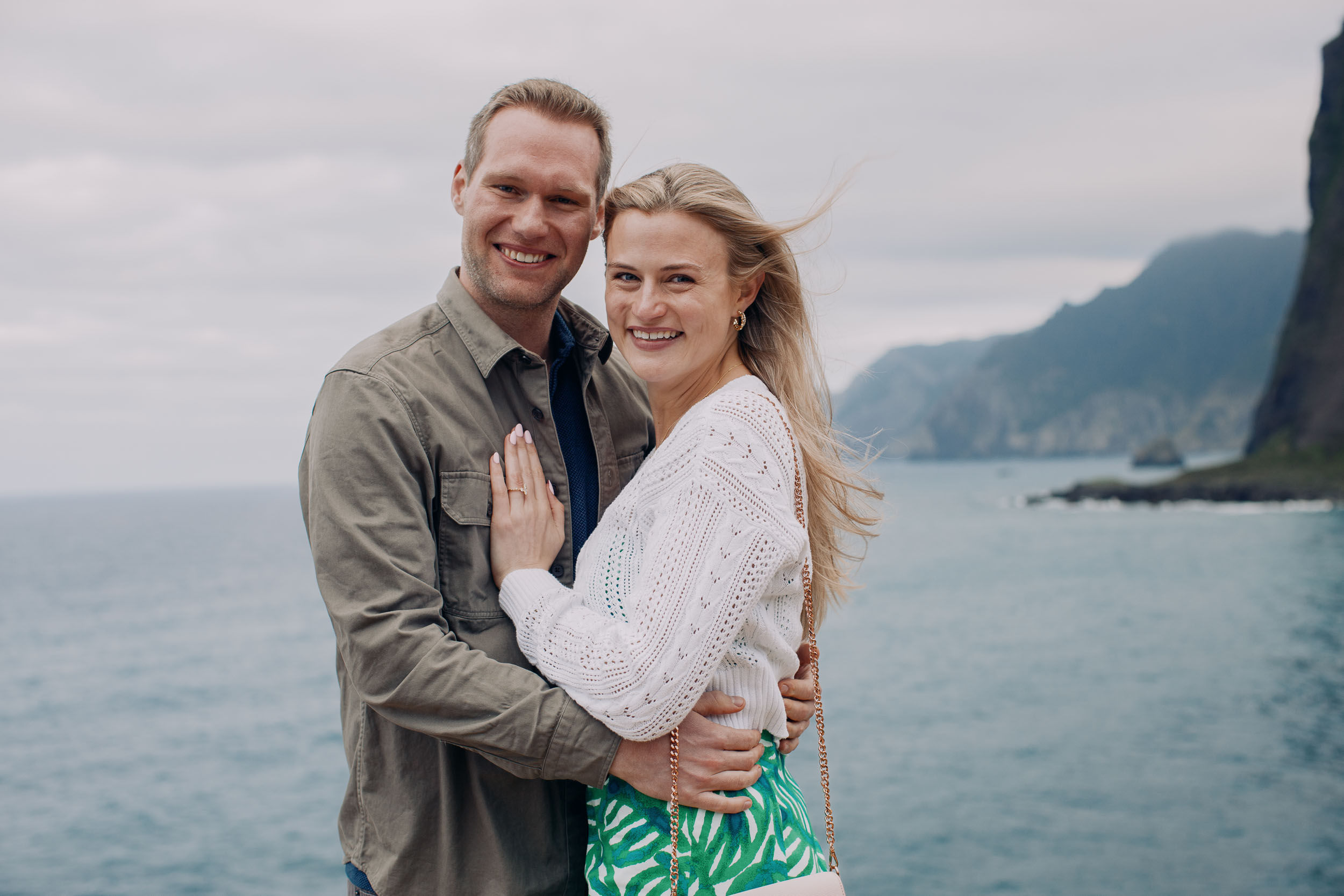 Couple embracing at rocky viewpoint, Funchal, Madeira