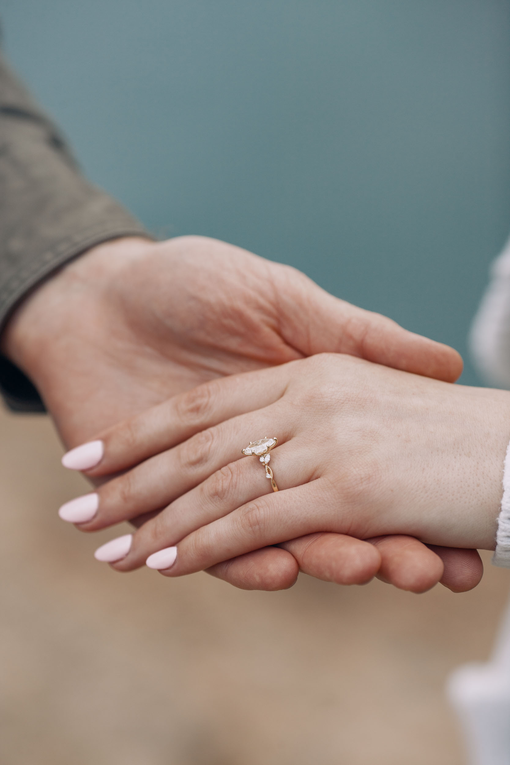 Man placing engagement ring on woman's hand, Guindaste viewpoint, Madeira