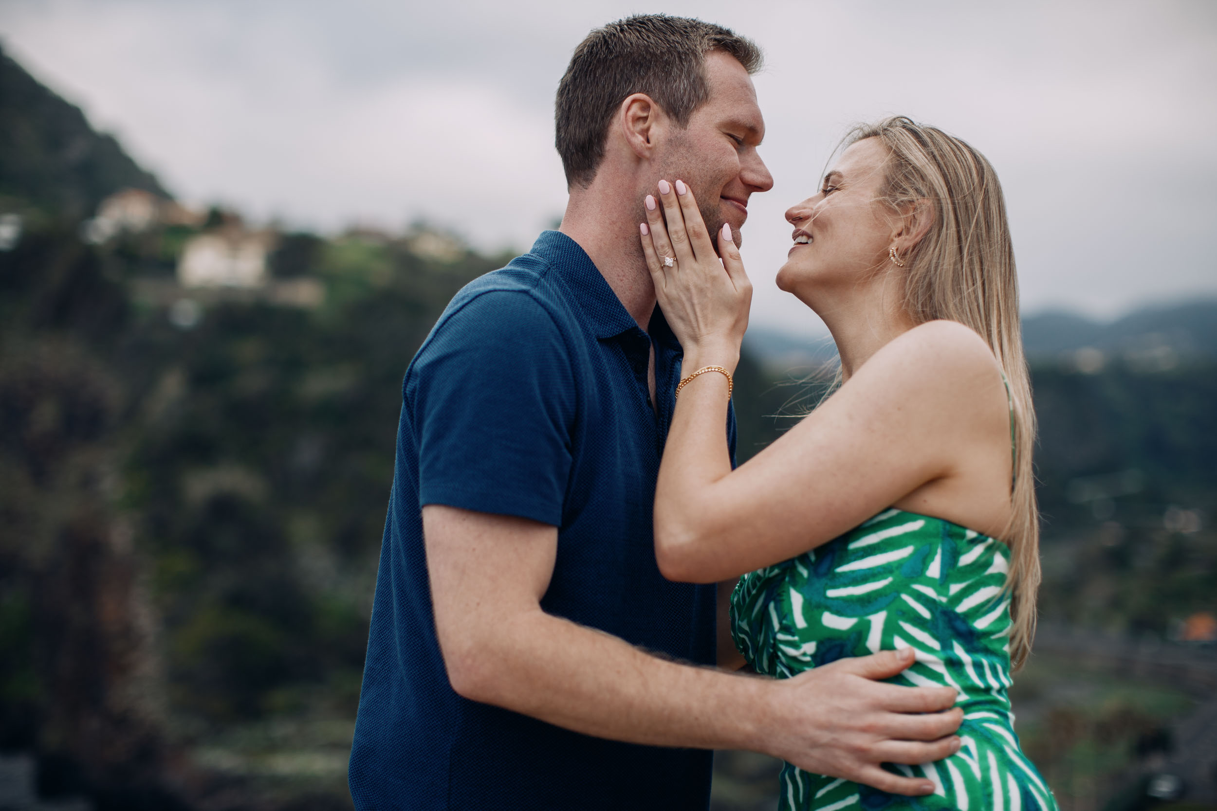Couple laughing at clifftop after proposal, Funchal, Madeira