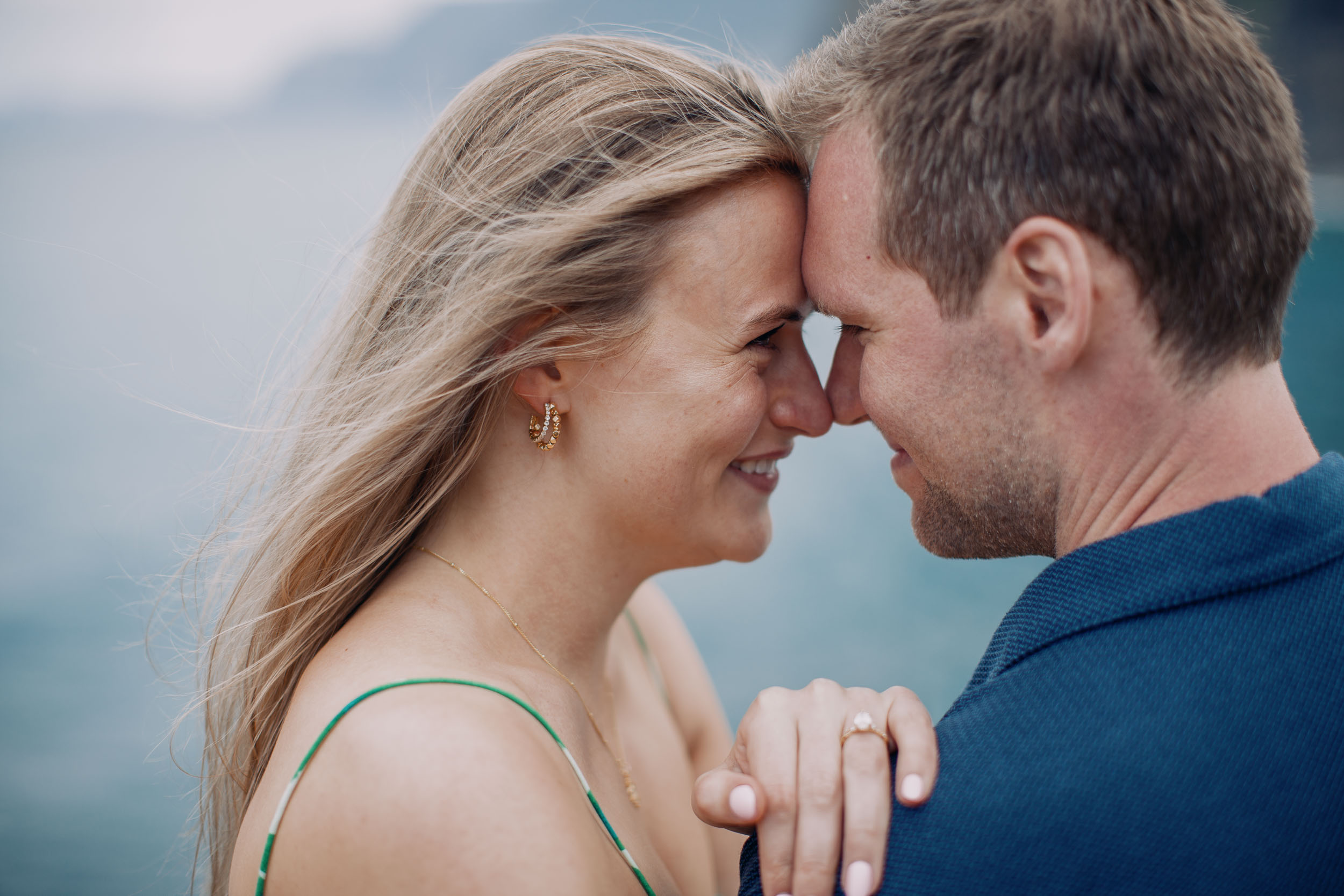 Couple embracing at rocky viewpoint, Funchal, Madeira