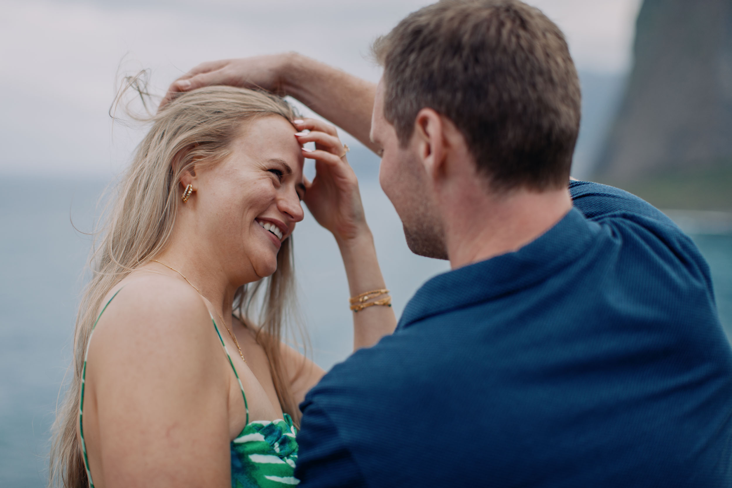 Man placing engagement ring on woman's hand, Guindaste viewpoint, Madeira