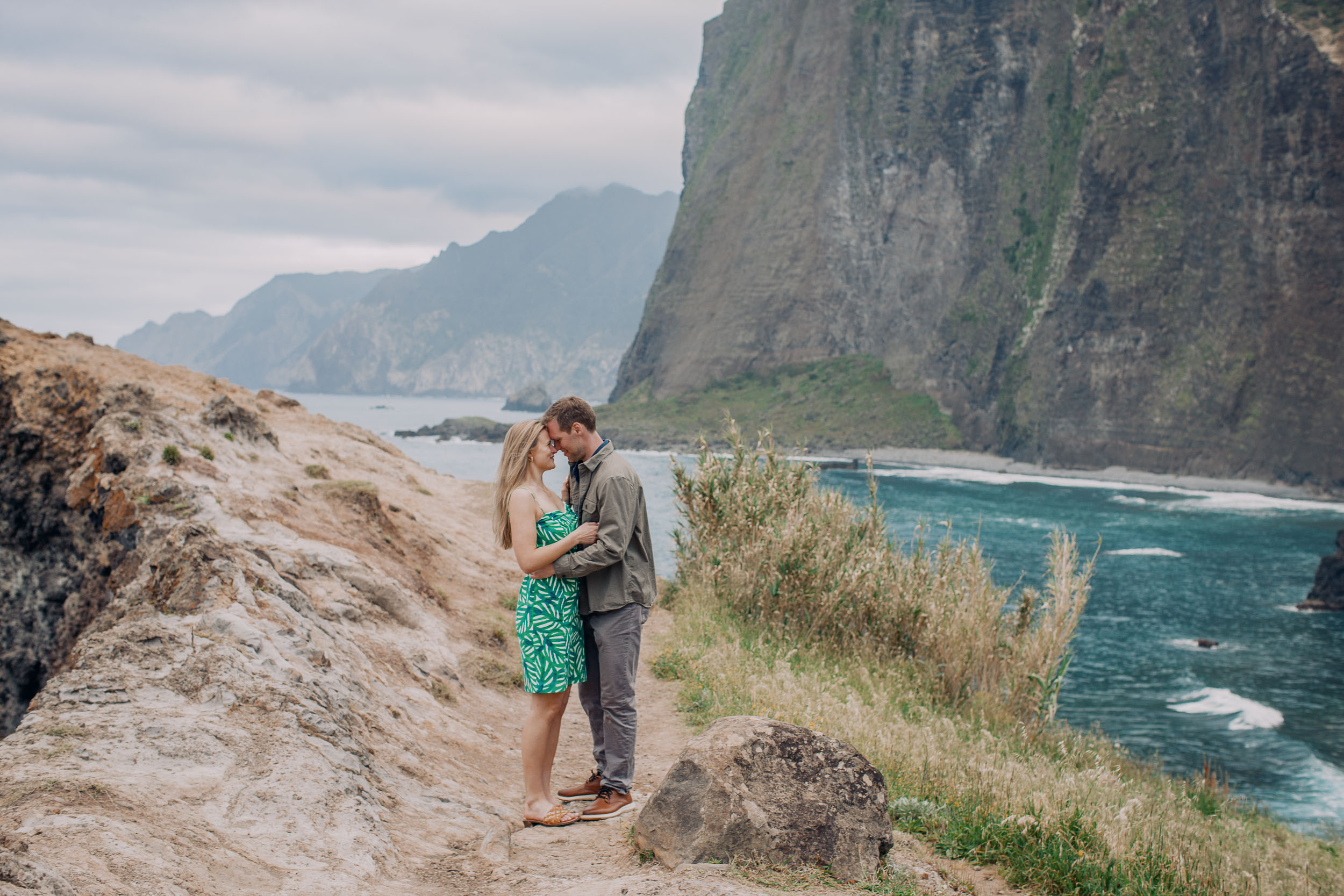 Man placing engagement ring on woman's hand, Guindaste viewpoint, Madeira