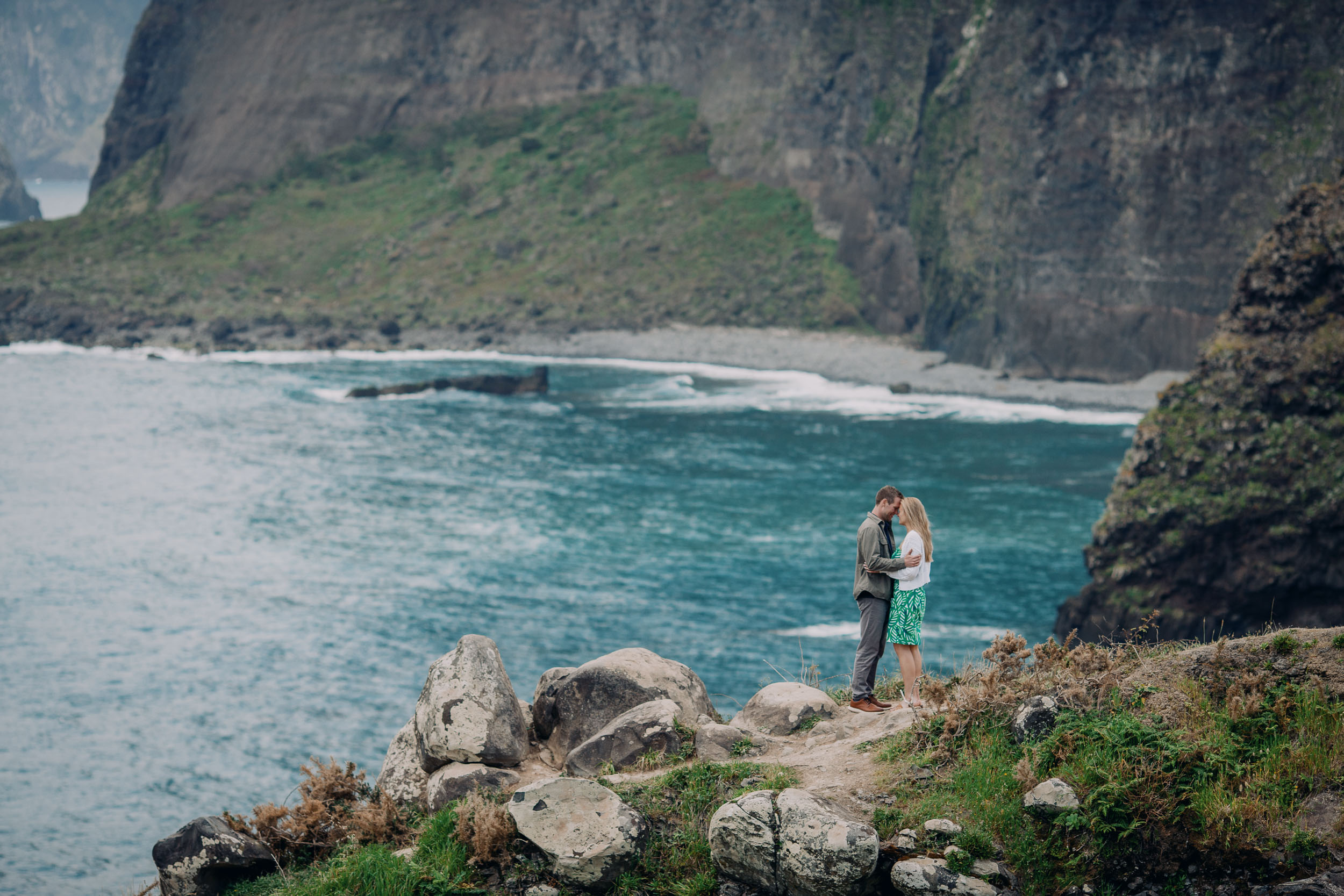 Couple embracing at rocky viewpoint, Funchal, Madeira