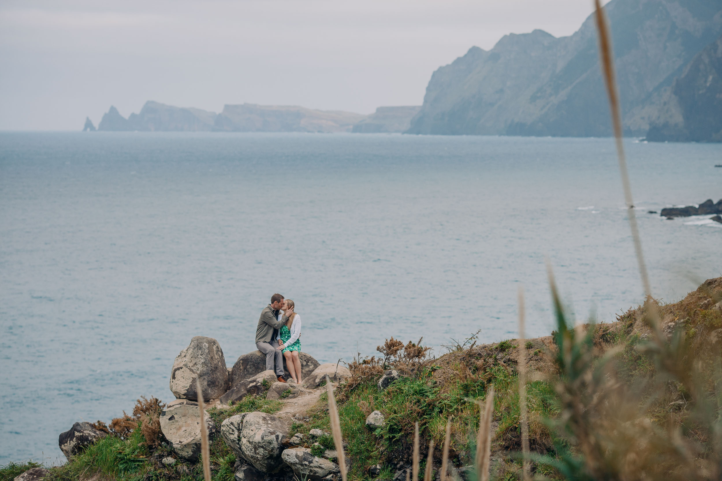 Man placing engagement ring on woman's hand, Guindaste viewpoint, Madeira