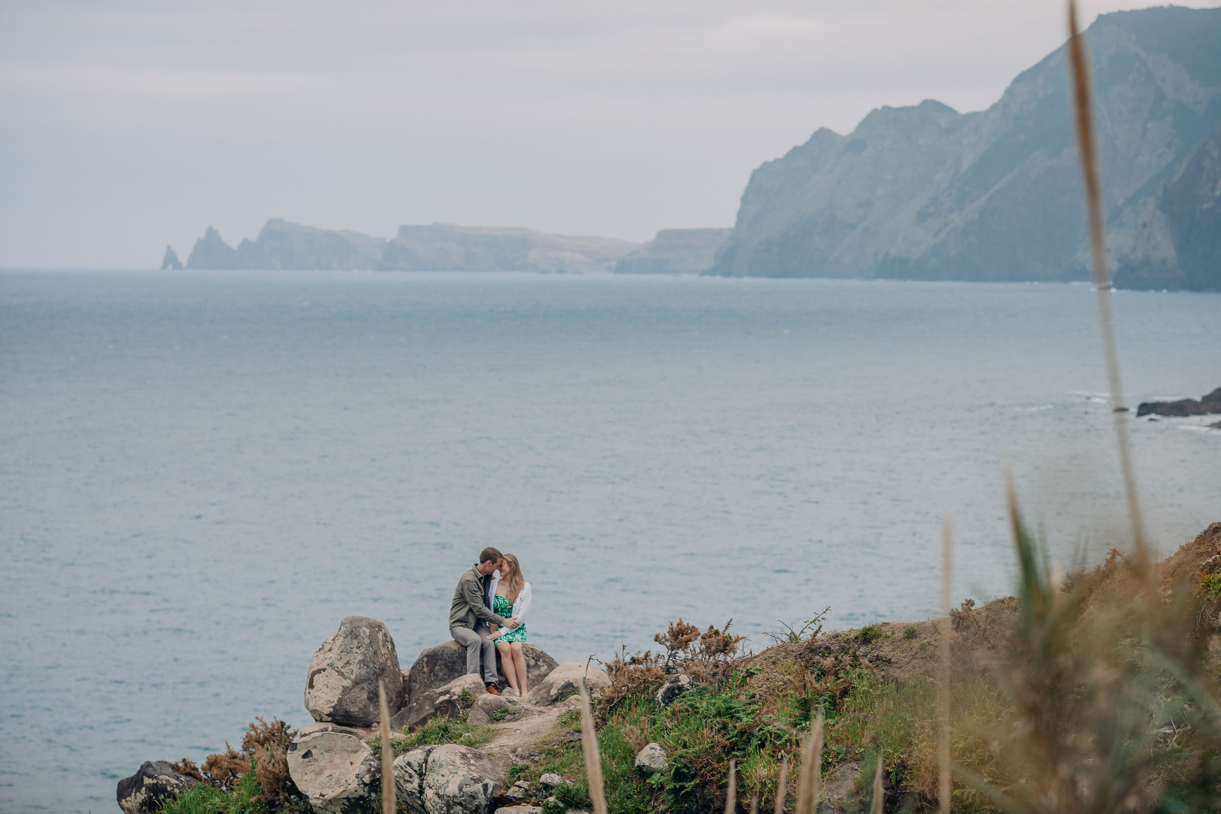Couple laughing at clifftop after proposal, Funchal, Madeira