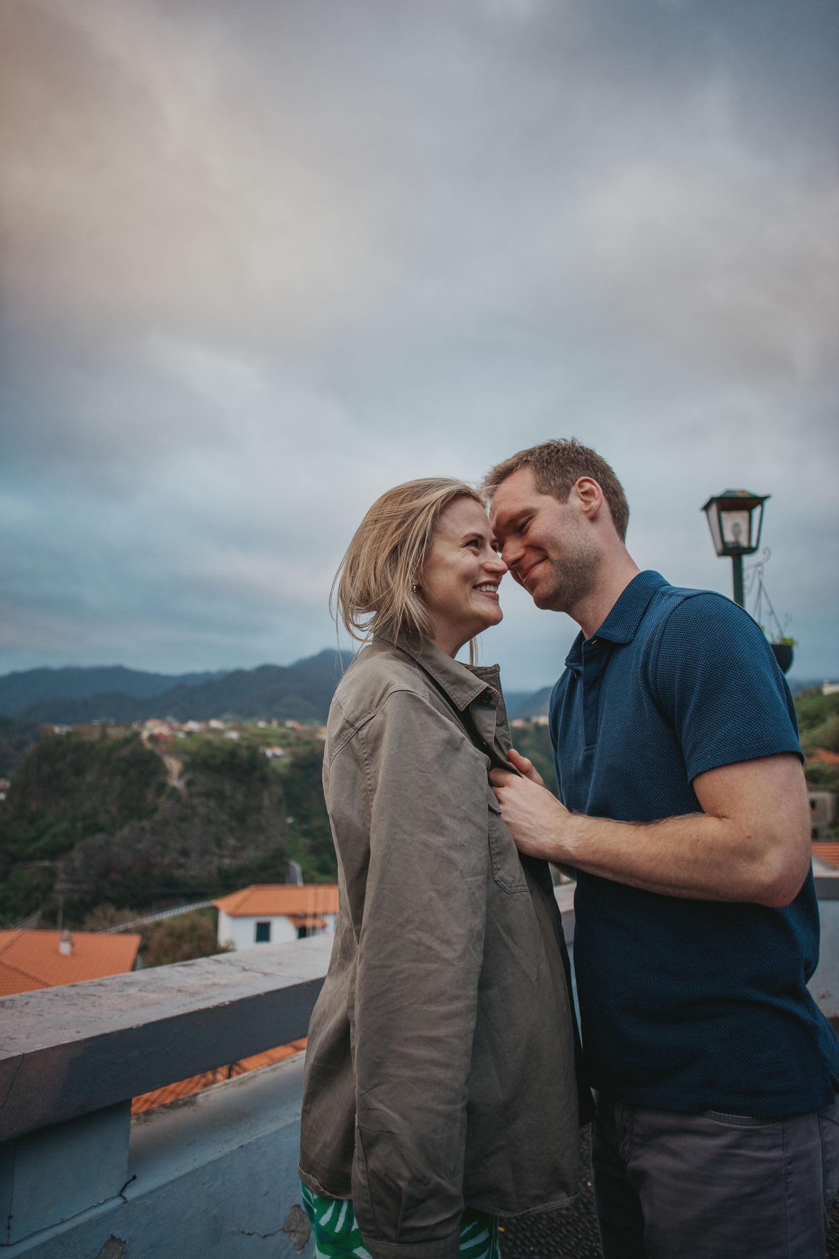 Man placing engagement ring on woman's hand, Guindaste viewpoint, Madeira