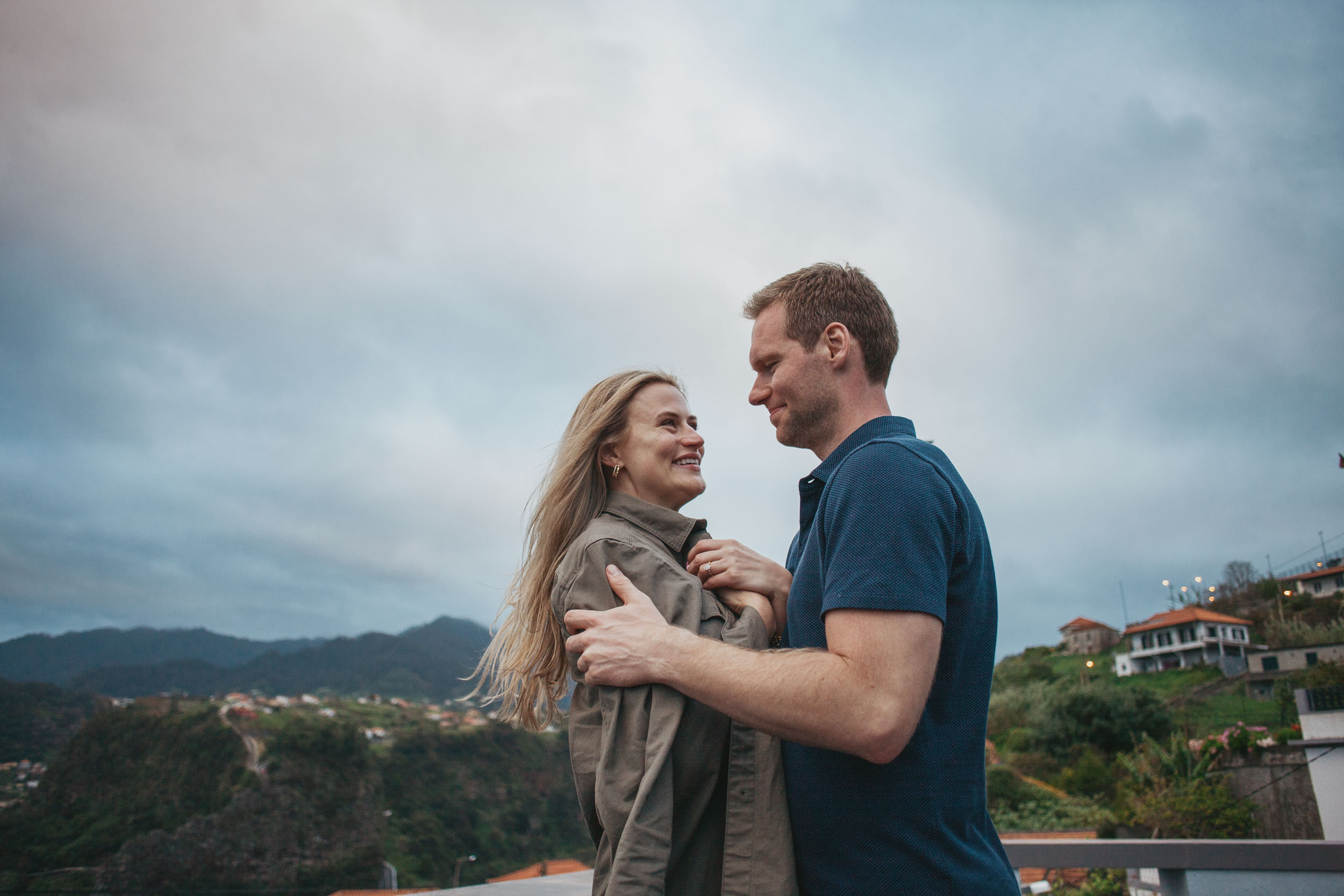 Couple laughing at clifftop after proposal, Funchal, Madeira