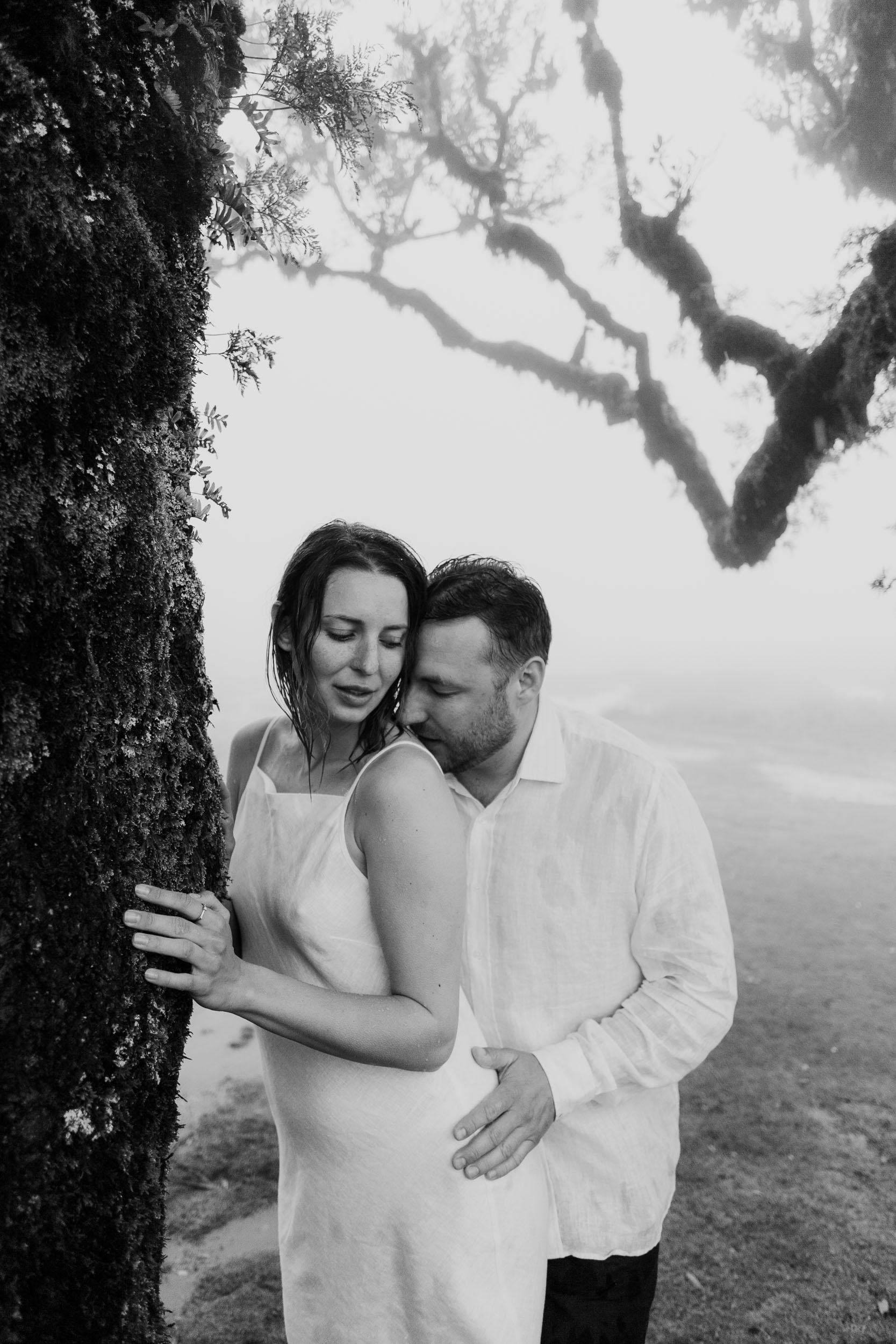 Quiet moment by an ancient laurel tree, white linen against grey fog, Fanal Forest, Madeira