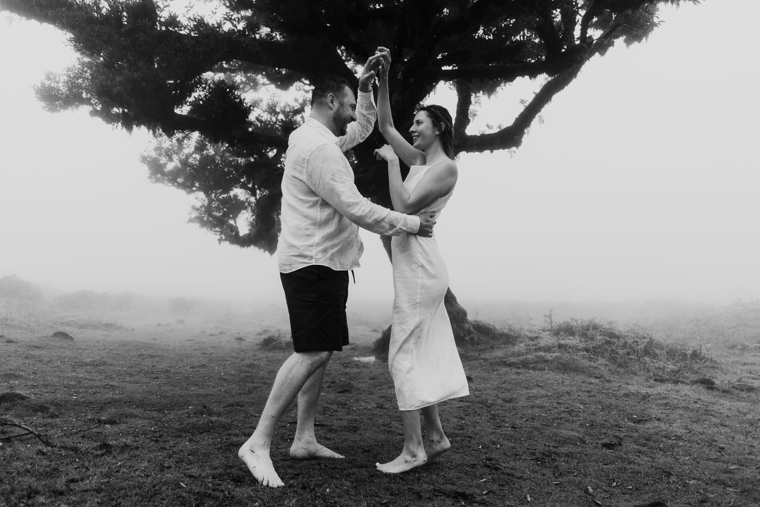 Couple walking together through the moss-covered laurel grove at Fanal, Madeira