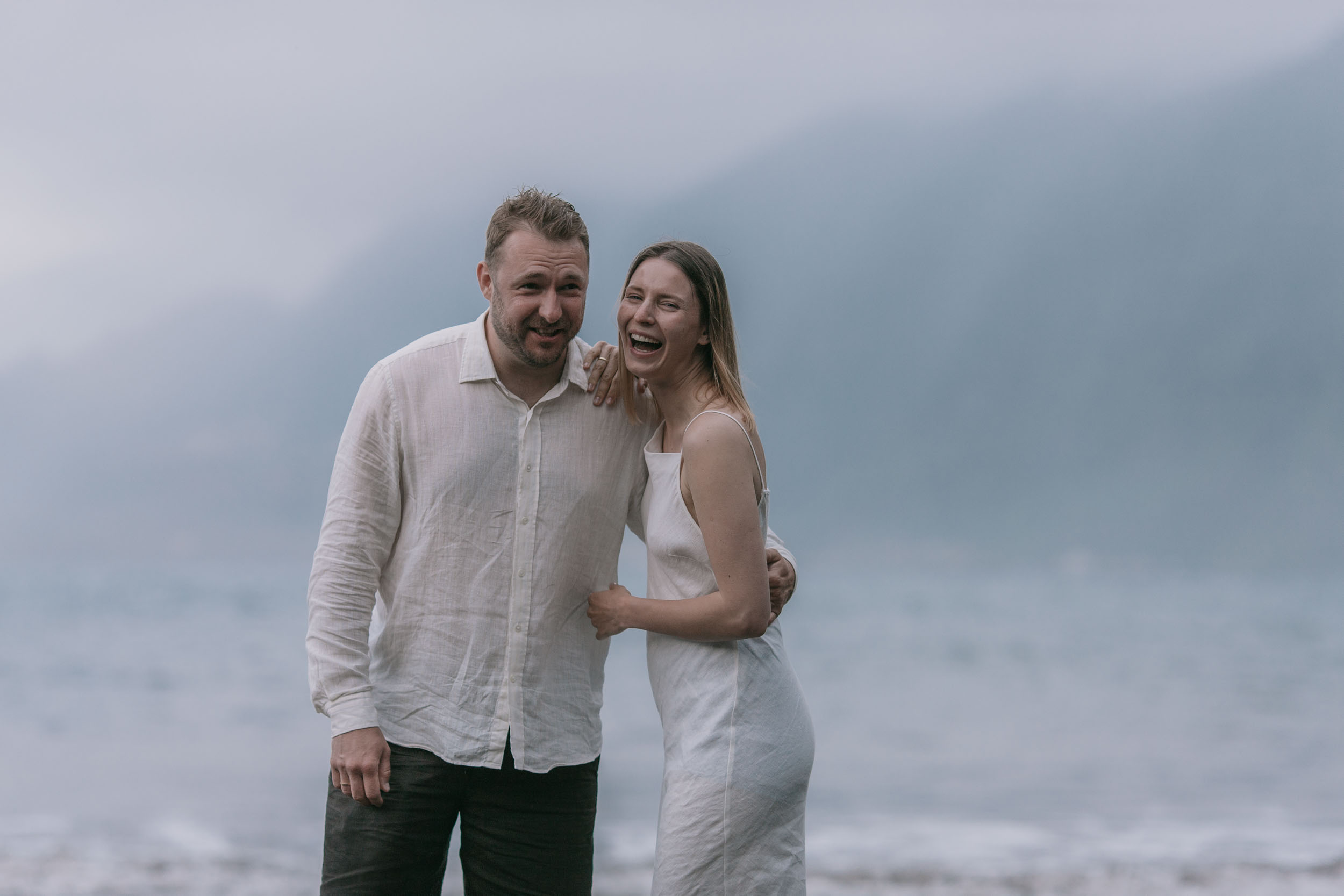 Empty stretch of black sand and Atlantic waves, the couple as silhouettes near the surf, Madeira
