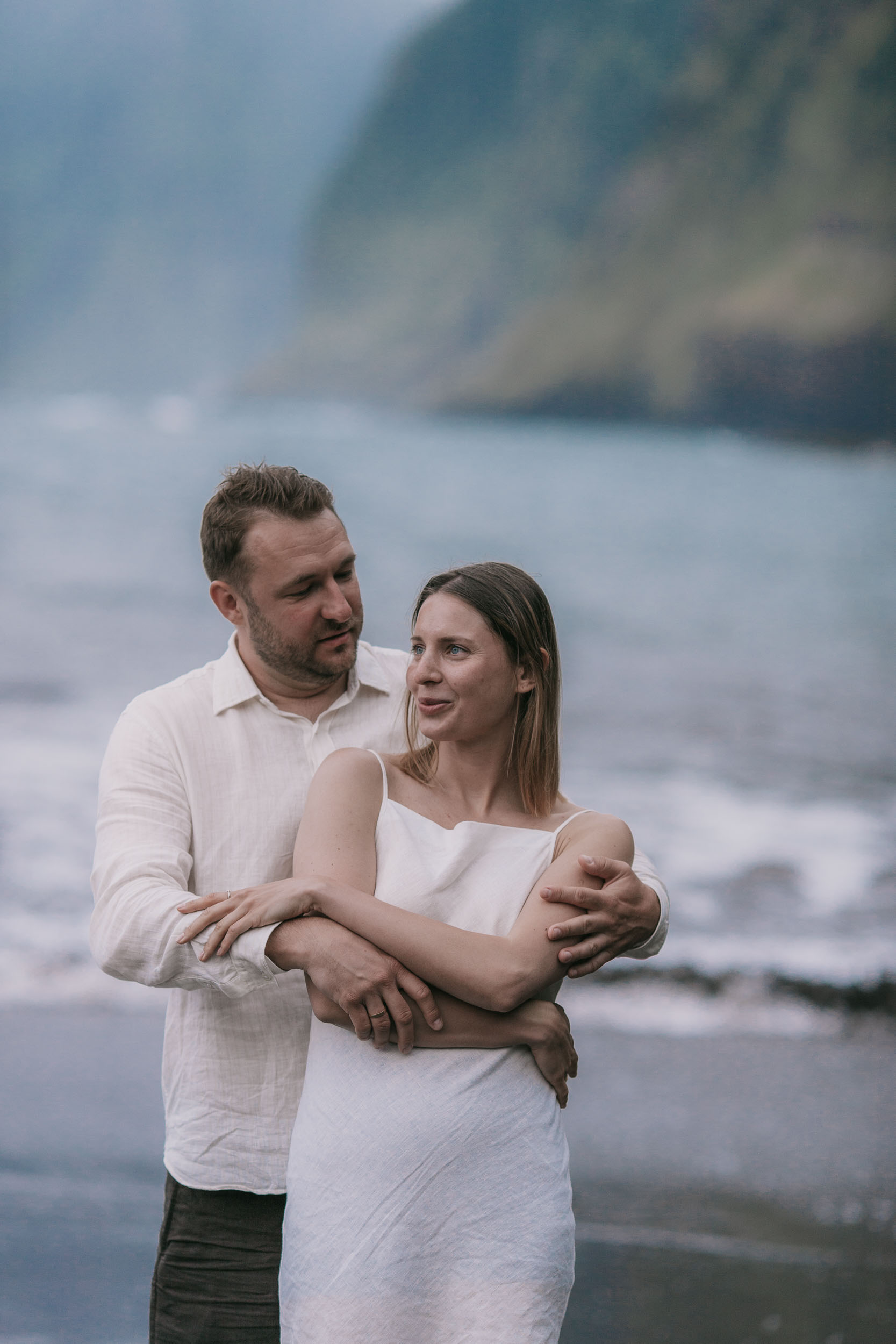 Long embrace on a black sand beach at dusk, north Madeira coast