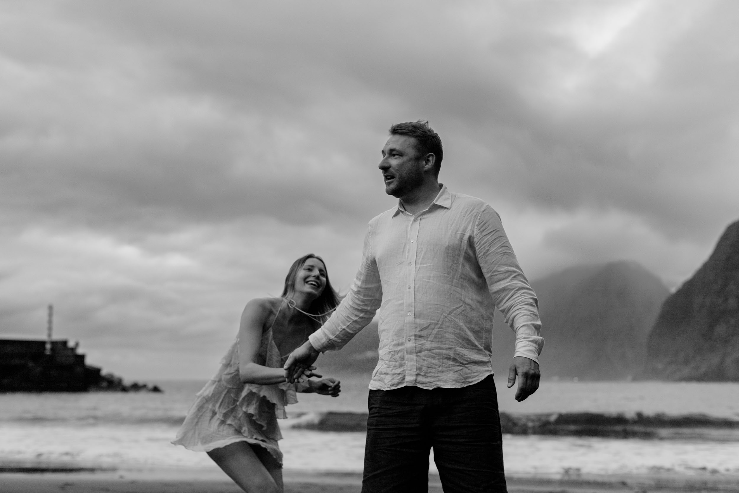 Black and white. Couple integrated into the rocks and surf of the north Madeira coast