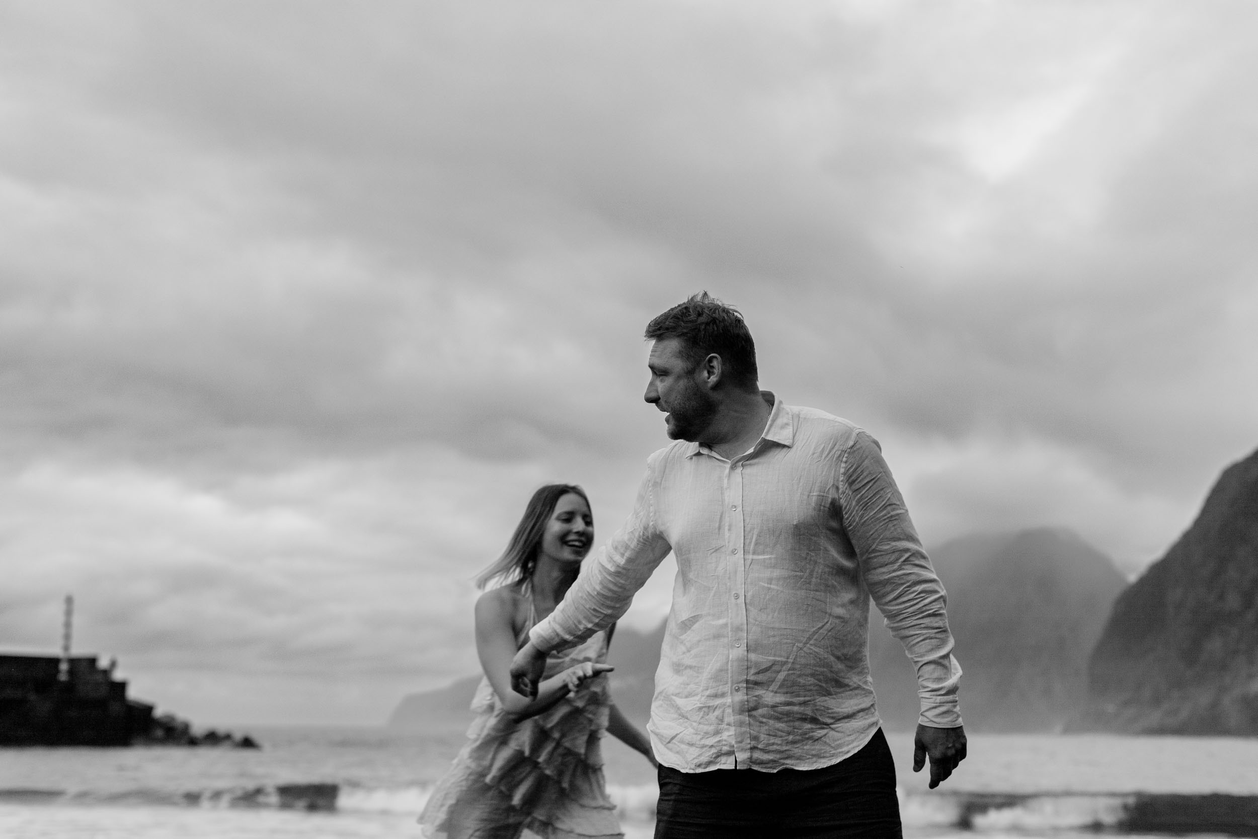 Black and white intimate close-up, side faces against the soft sky, Madeira