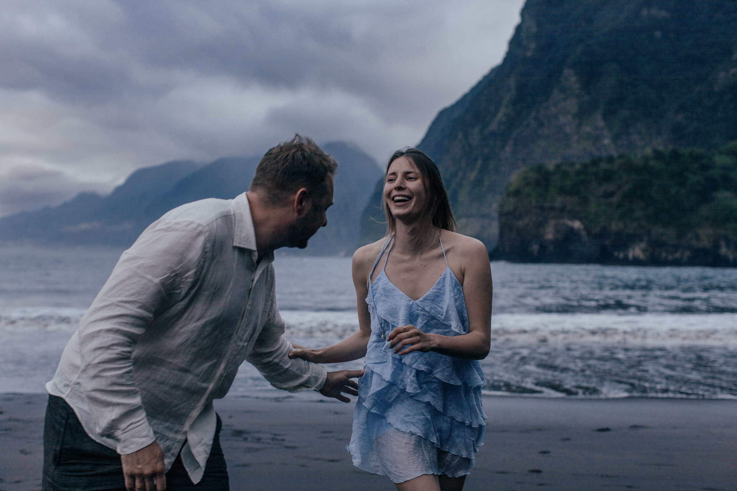 Black and white. Couple integrated into the rocks and surf of the north Madeira coast