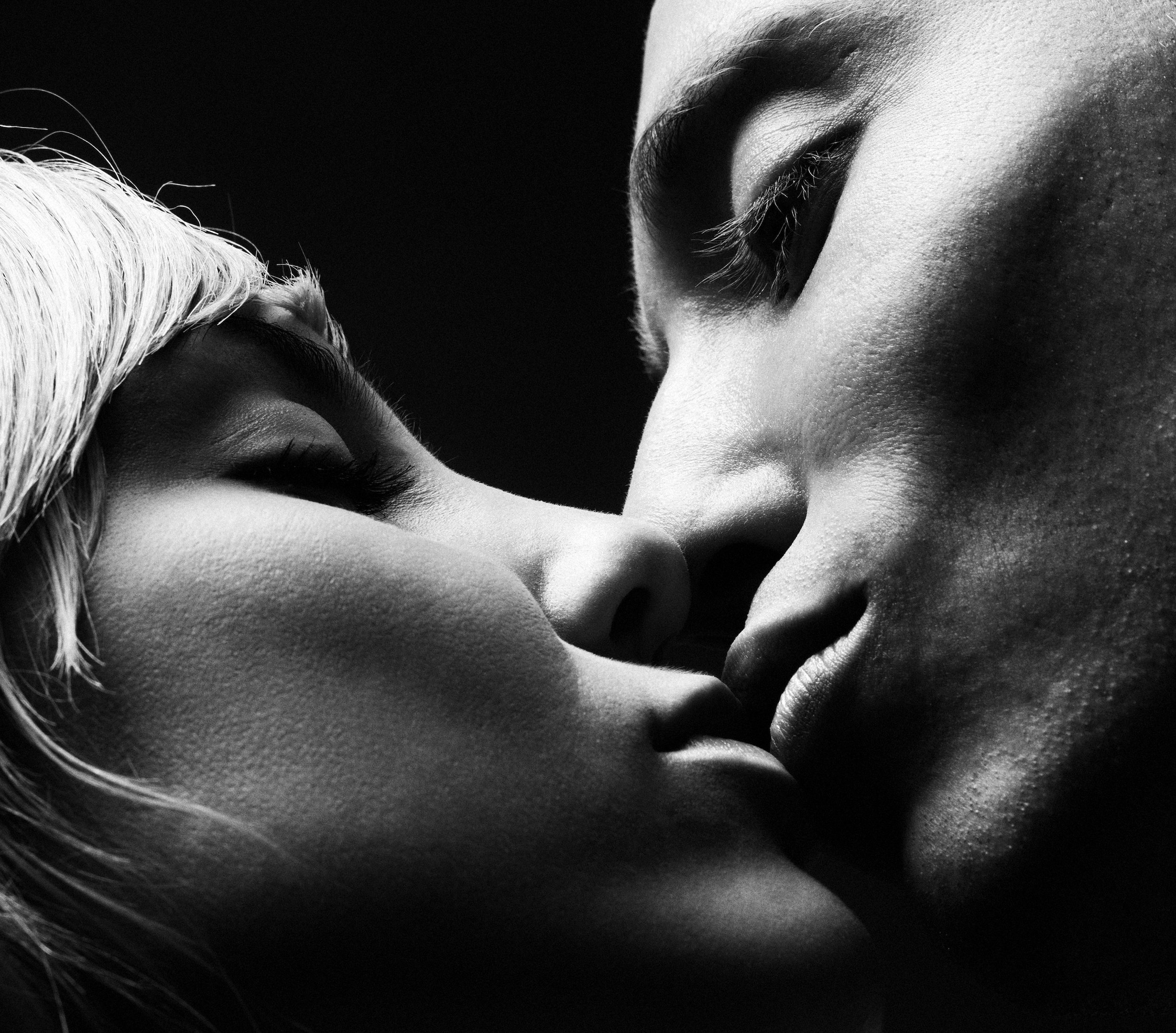 Black and white close frame of a bride and groom about to kiss